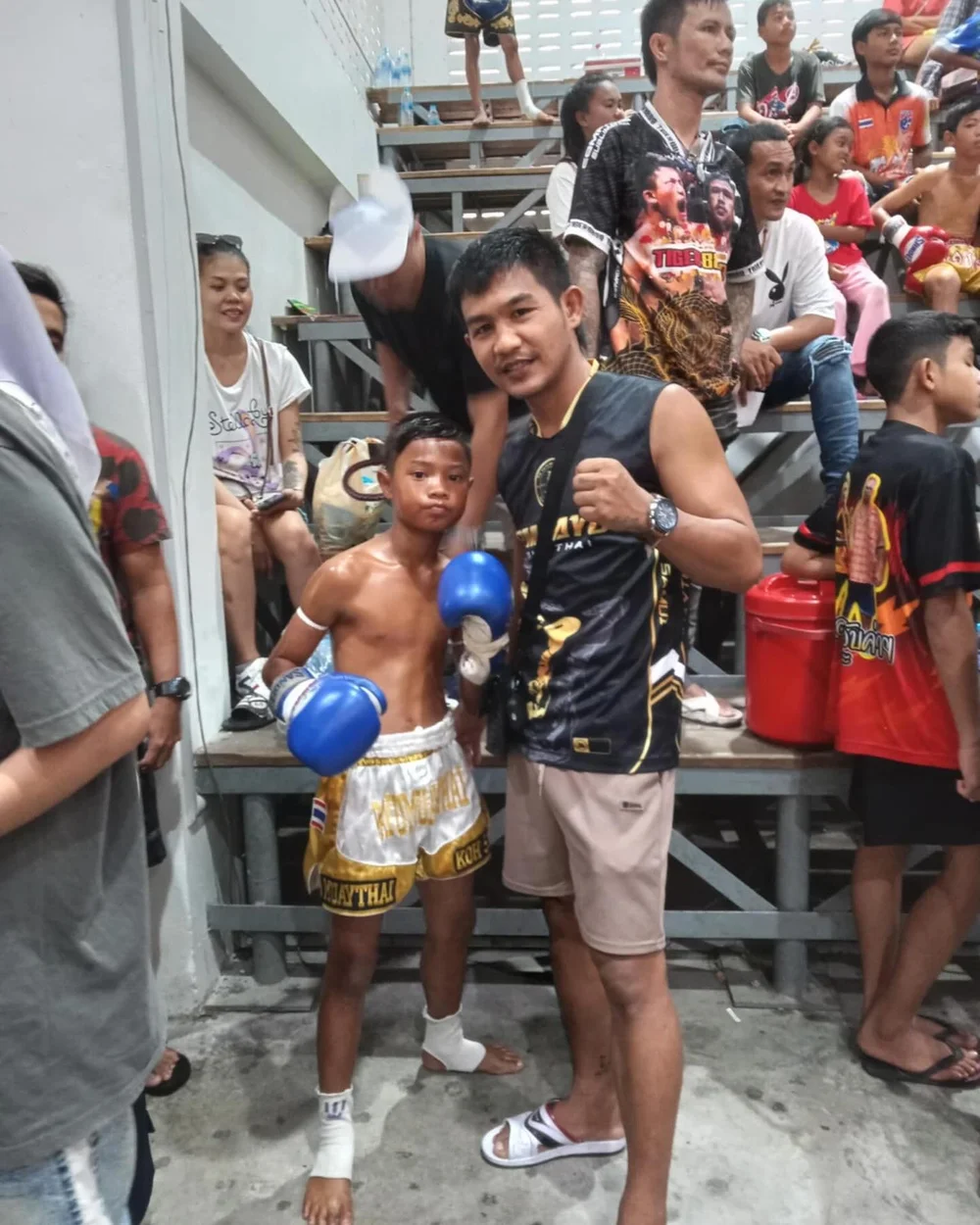 Coach wrapping a fighter’s gloves before a match