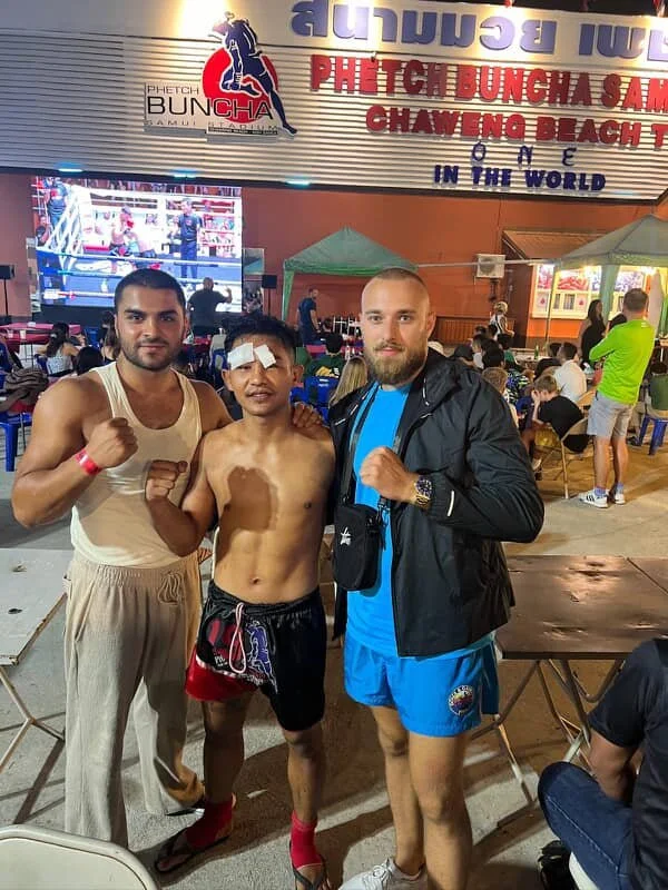 Referee raising a young fighter’s hand in victory
