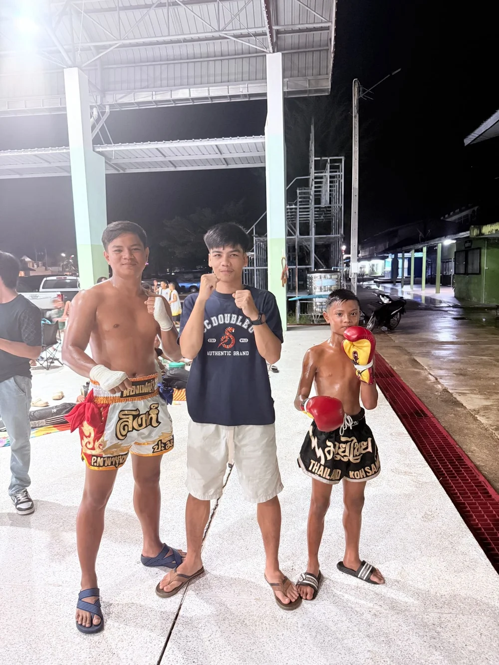 Fighter and team posing after a night match