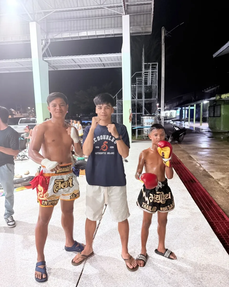 Fighter and team posing after a night match