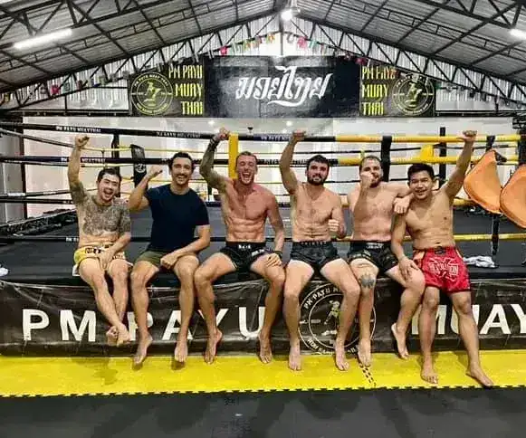 Group of trainees sitting on the ring at PM PAYU Muaythai, Koh Samui