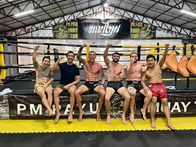 Group of trainees sitting on the ring at PM PAYU Muay Thai, Koh Samui