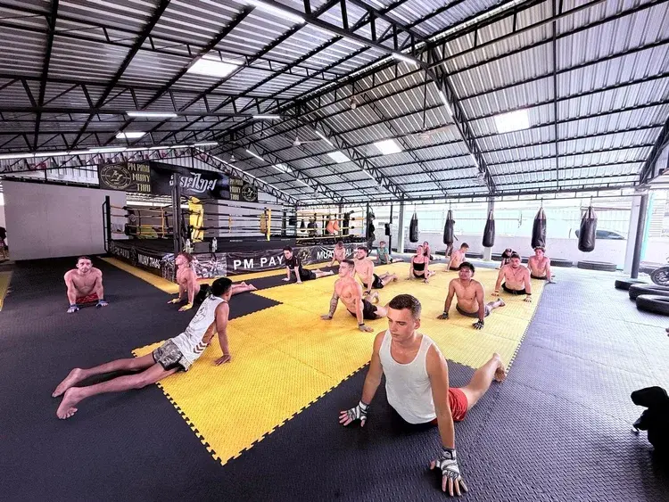 Group stretching class at PM PAYU Muay Thai gym, Koh Samui