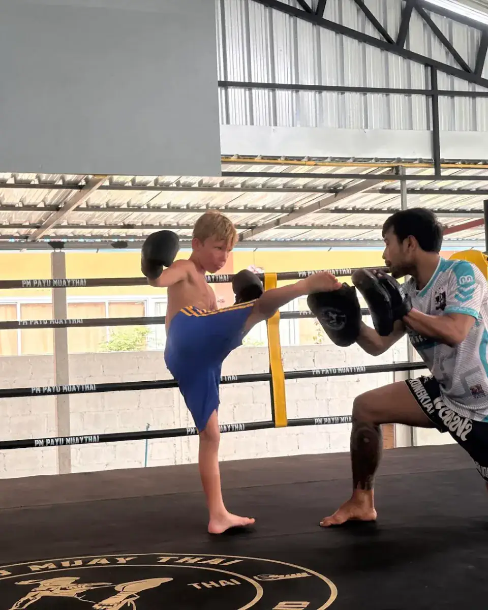 Kru Kong with a young student after pad work at PM PAYU Muaythai