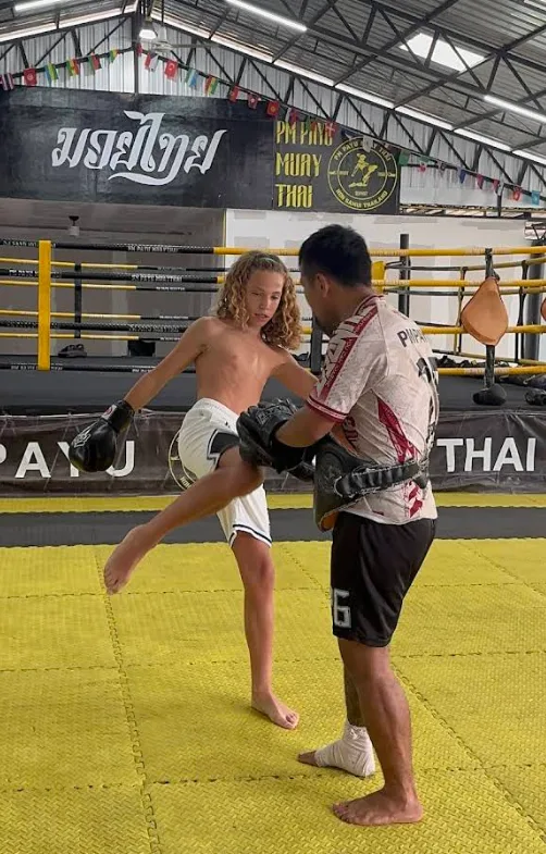 Teen trainee holding pads during training at PM PAYU Muay Thai, Koh Samui