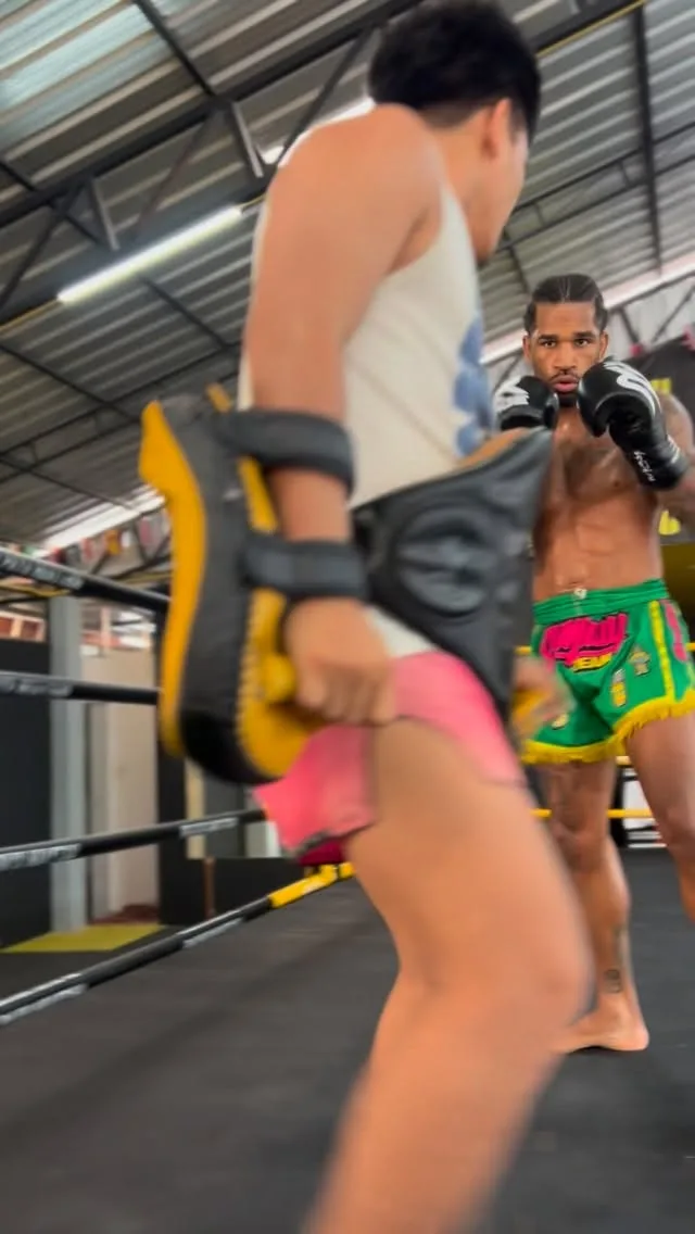 Singdam and Gomin on pads during fight camp training
