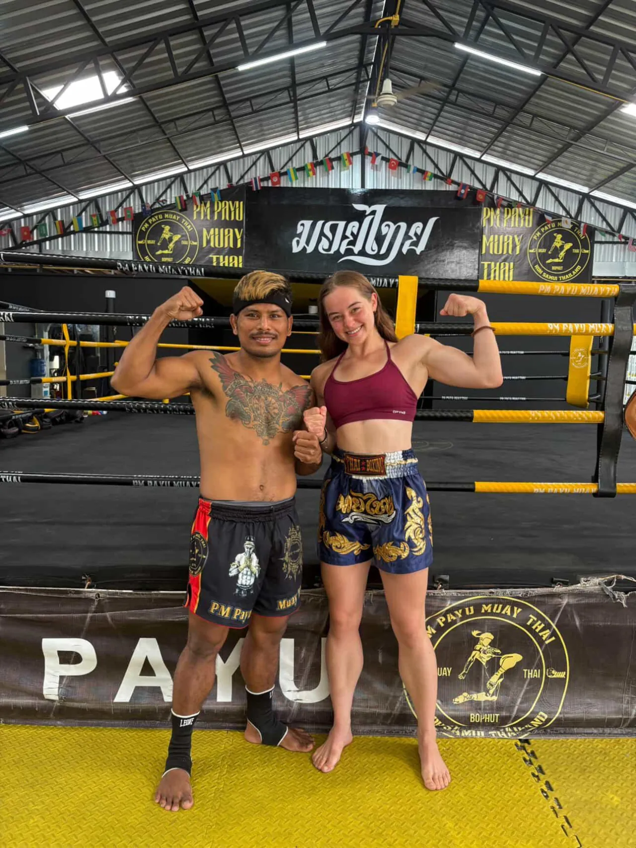 Kru Koban and Clover flexing in the ring at PM PAYU Muay Thai, Koh Samui
